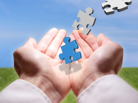 Conceptual photography representing the hands of a man who finds a piece of puzzle rare colorの写真素材