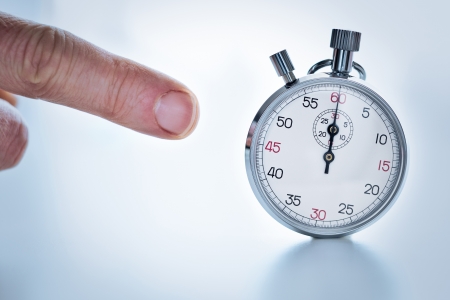 Photograph showing a finger pointing a stopwatchの写真素材