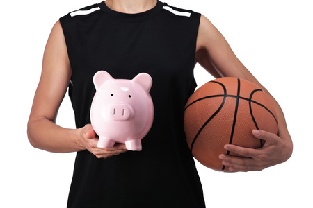 photography of a basketball player holding a piggy bankの写真素材