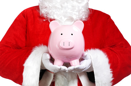 photography Close up of Santa Claus holding a piggy bankの写真素材
