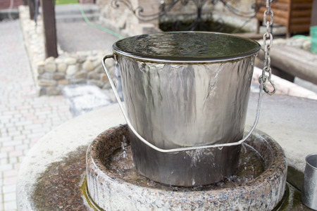 water is coming out of a metal bucketの写真素材