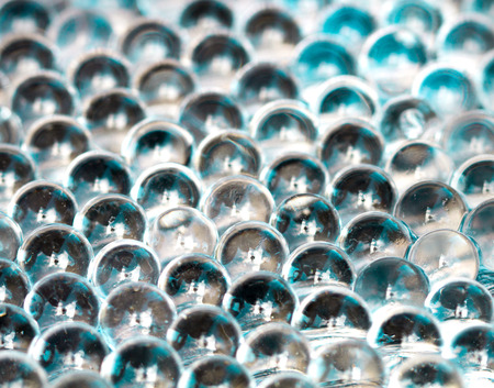 Blue shiny water gel balls. Macro photo, can be used both for advertising or cosmetics and for medicine. Abstract background.の写真素材