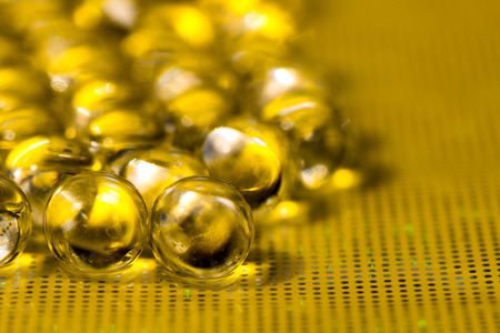 Gold shiny water gel balls. Macro photo, can be used both for advertising or cosmetics, jewellery and for medicine. Abstract background.の写真素材