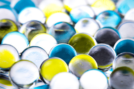 Blue and yellow water gel balls. Macro photo, can be used both for advertising or cosmetics and for medicine. Abstract background.の写真素材
