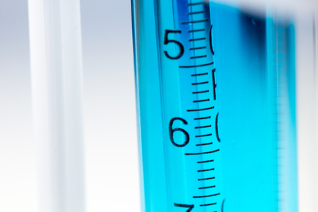 Pipette in test tube with blue liquid water in laboratory.の写真素材
