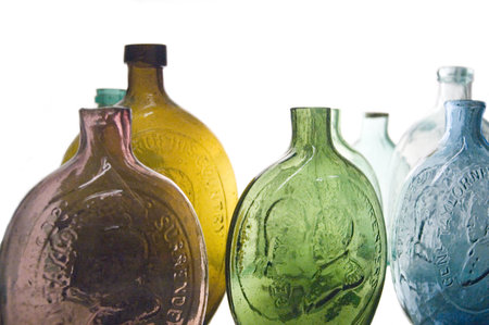 Antique bottle collection over a white background.の写真素材