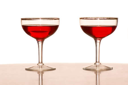 Two wine glasses with red wine against a white background.の写真素材