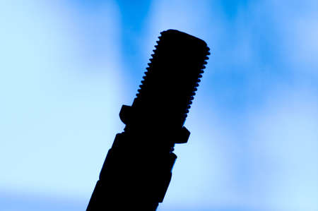Silhouette of a cable connection against a blue gradient background. Good technology concept photo.の写真素材