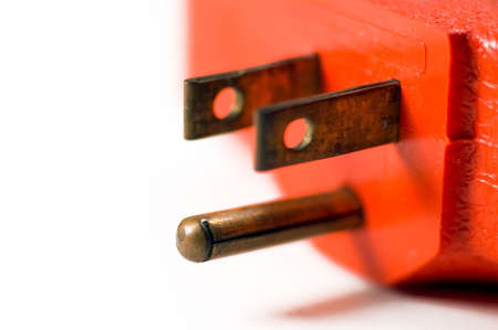 Macro of a three prong electrical plug. Shallow depth of field, focus is on the prongs. Lots of detail and makes a good concept photo.の写真素材