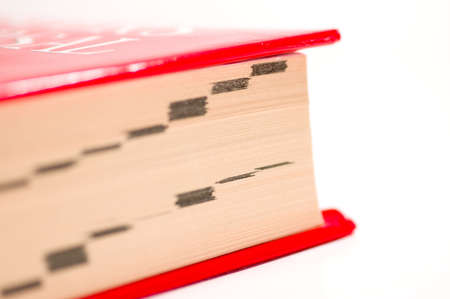 Close up of the index tags on a reference books edges. Isolated on a white background. Shallow depth of field.の写真素材