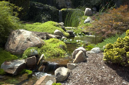 Beautiful and peaceful Japanese water garden. Complete with three small waterfalls.の写真素材