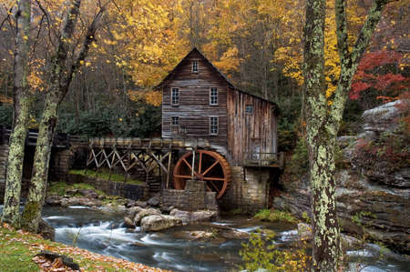 Beautiful colorful October autumn colors surround the Glade Creek Grist mill in West Virginia. A very popular destination for tourism in the fall. One of several of this mill I have in my gallery.の写真素材