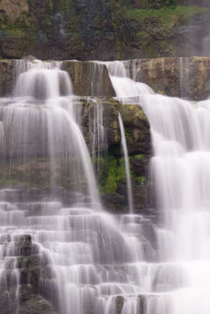 Chittenango Falls in central New York state. This powerful and beautiful waterfall tumbles across many rock ledges creating a beautiul scene and an almost tropical setting with the luch green, moss and fern covered rocks. の写真素材