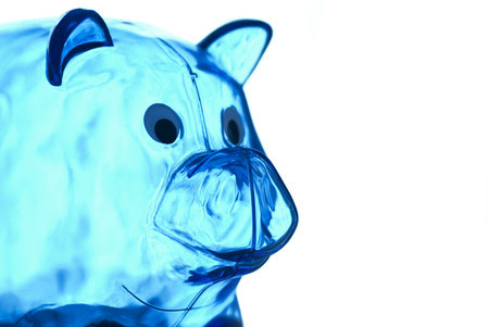 A close-up of a transparent blue piggy bank. Isolated on a white background. nice photo for a savings concept.の写真素材