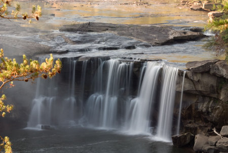 Cumberland falls in Kentucky.  This waterfall  is located near the city of Corbin in Cumberland falls state park.  Photo was taken in mid October during a drought. Even with a drought the waterfall is impressive. の写真素材