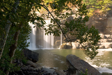 Partial view of Cumberland falls in Kentucky.  Framed by a beautiful tree. This waterfall  is located near the city of Corbin in Cumberland falls state park.  Photo was taken in mid October during a drought. Even with a drought the waterfall is impressiveの写真素材