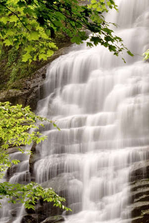 A secluded waterfall in the forest. Beautiful graceful details captured in the water as it tumbles...