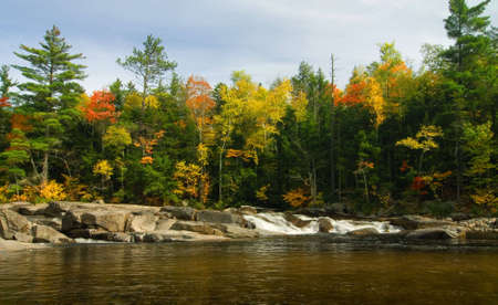 Lower Falls along the Swift River just off the Kancamagus Highway in the White Mountains of New Hampshire. Peak fall colors add beauty to the scene.の写真素材