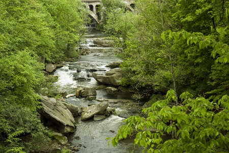 Berea Falls  in  Berea Ohio. This large series of cascades l is found in the middle of an urban area near Cleveland Ohio. Very large boulders scatered along the river create the rapids. の写真素材