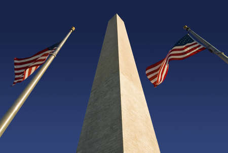 The Washington Monument  flanked by two American flags. Located in Washington DC along the National Mall.の写真素材