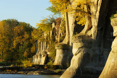 Beautiful autumn sunrise at the Interurban bridge in Toledo Ohio on the Maumee river  The bridge is abandoned and now has trees and vegetation growing out of it  の写真素材