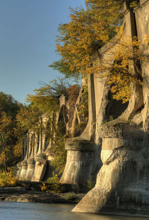Beautiful autumn sunrise at the Interurban bridge in Toledo Ohio on the Maumee river  The bridge is abandoned and now has trees and vegetation growing out of it  の写真素材