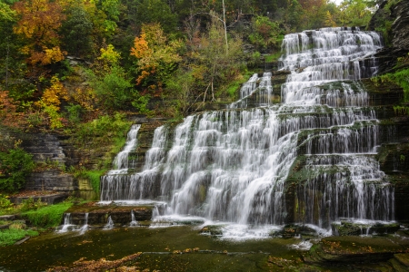 Hector falls  in New York surrounded by trees and plants with peak fall colors  A beautiful roadside waterfall just north of Watkins Glen の写真素材