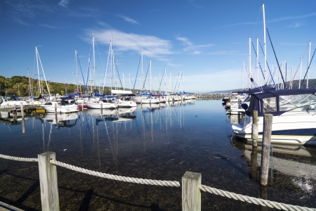 Lots of sails boats at the boat marina harbor at the southern end of Seneca lake in Watkins Glen New York on a beautiful blue sky day in autumn.の写真素材