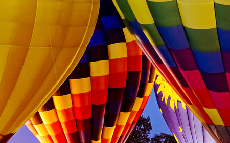 Colorful hot air balloons doing a night glow burn to light up the balloons for the crowd.の写真素材