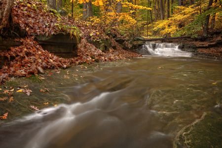 One of the many scenic waterfalls along the Sulpher Springs Creek in Ohio during peak fall colors....