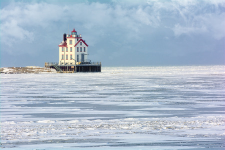 The Lorain Lighthouse is a historic landmark on the shores of Lake Erie, one of the Great Lakes. Seen here in winter with snow and ice.の写真素材