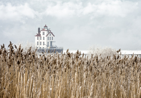 The Lorain Lighthouse is a historic landmark on the shores of Lake Erie, one of the Great Lakes. Seen here in winter with snow and ice.の写真素材