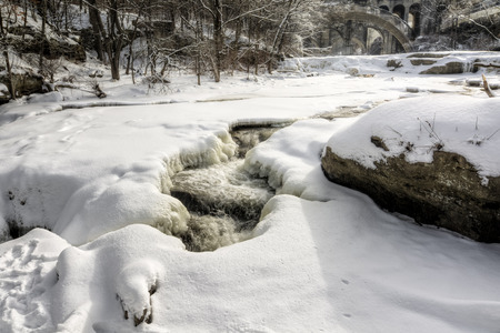 Photo of Berea Falls Ohio during winter. This cascading waterfall is in Berea Ohio. A fresh coating of snow makes for a beautiful winter wonderland scene.の写真素材