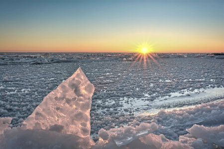 Lake Erie sunrise. Seen here in winter frozen with chunks of broken ice.の写真素材