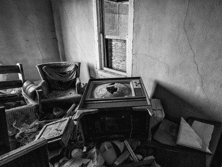 The inside of an abandoned house. This house has been abandoned for years and is showing the signs of vandalism and deterioration.の写真素材