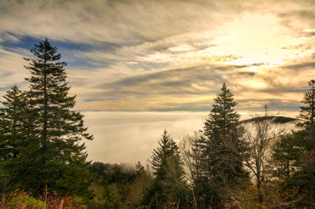 Early morning mountain sunrise with fog in the valleys below. Taken in late October along the scenic Blue Ridge Parkway in Western North Carolina.の写真素材