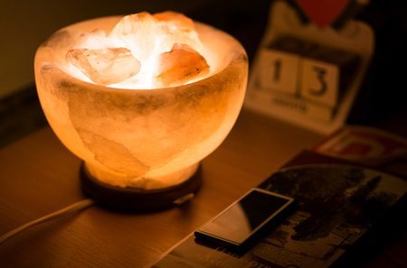 Salt lamp on the wooden tableの写真素材