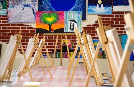 KIROV, RUSSIA - JUNE 23, 2017: Canvases standing in a row on the long table in the local art studio in preparation for the artistic masterclassのeditorial素材