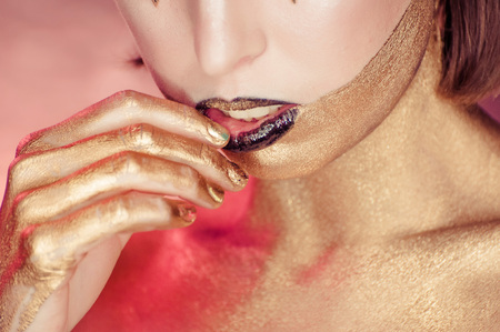 Studio Shot of a Golden Glittery Body Womanの写真素材