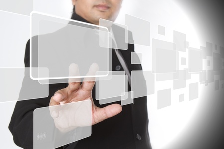 businessman pushing on a touch screen interfaceの写真素材