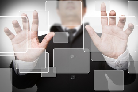 businessman pushing on a touch screen interface
