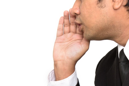 businessman say, talking, hold hand near open mouth gesture to empty copy space, handsome young business man happy smile wear elegant suit and tie isolated over white background, concept of speakingの写真素材