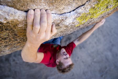 A rock climber executing a very strenuous move.の写真素材