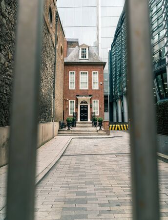 Narrow British Red Brick House within Dense Cityscape, London, UKの写真素材