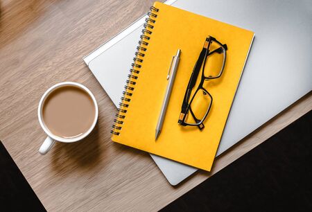 WFH - Work from Home Flatlay Photo of Desk with Laptop, Notepad, Glasses and Cup of Teaの写真素材
