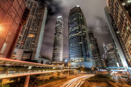 Wide Angle View of Central Hong Kong City Skyline with Busy Roads and Streaks of Car Lights at Nightの写真素材