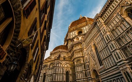 Wide Angle View of Florence Cathedral - Santa Maria del Fiore at Sunset with Golden Light in Florence, Italyの写真素材