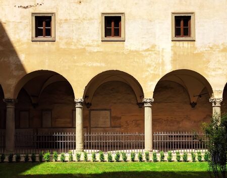Flat Symmetrical View of Traditional Italian Facade & Arcade under Noon Sunlight in Florence, Italyの写真素材