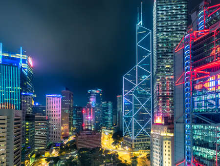 Hong Kong - 09 February 2018 - Rooftop View of Futuristic Dystopian City Skyline at Night with Neon...