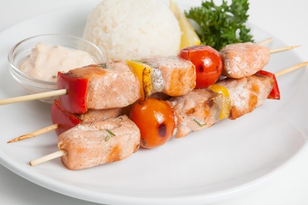 Prepared salmon kebab with vegetables and white riceの写真素材